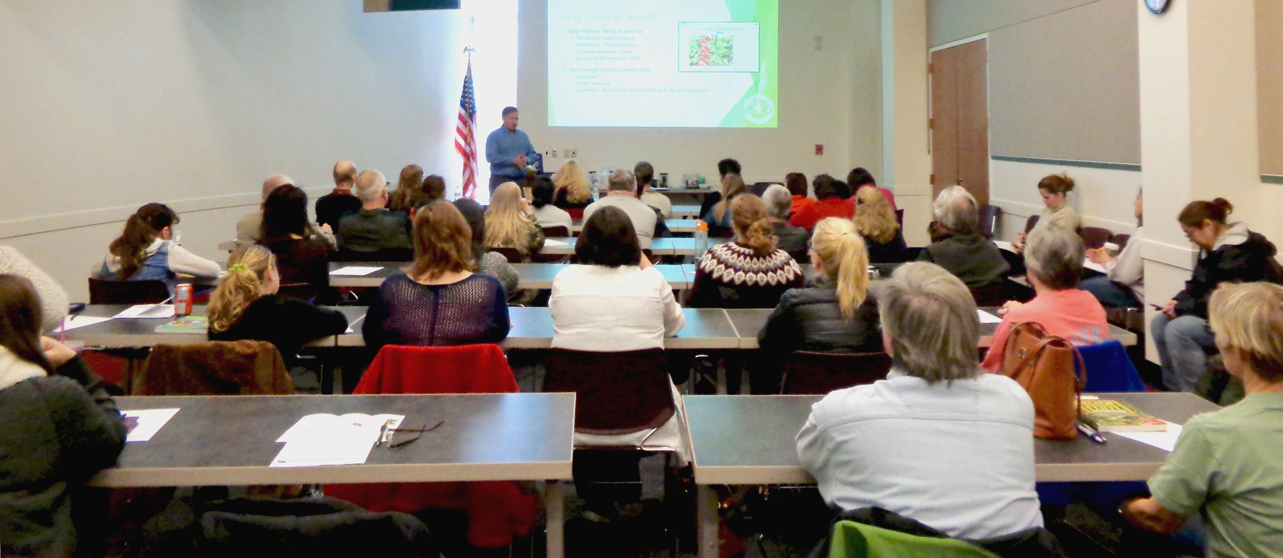 Master Gardener talking to a group of citizens to learn horticultural practices at the Library